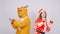 Young woman in santa claus hat and man in carnival costume of deer. Fun, holiday and christmas