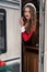 Young woman in santa costume resting at winter campsite