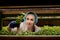 Young woman scientist analyzes and studies research on organic, hydroponic vegetable plots. Caucasian woman observes about growing