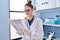 Young woman scientist reading document at laboratory