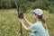 Young woman scientist zoologist sets camera trap for observing wild animals in forest to collect scientific data Environmental