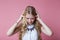 Young woman screaming from pain and holding her head with selective focus