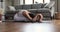Young woman seated on mat in forward bend yoga asana