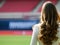 young woman seen from behind in a stadium, AI generated