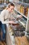 Young woman selected nuts in organic store