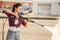 Young woman on self-service car wash