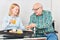 Young woman and senior having breakfast together