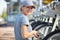 Young woman servicing rental public city bikes