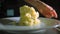 Young woman serving mashed potatoes on a plate, slow motion video