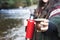 Young woman serving mate in a natural space. Beside a river. Latin beverage.