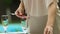 Young woman serving table for traditional family dinner, celebration at home