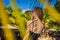 Young woman with the shadow of the palm leaf on her back. Relaxing on the seaside