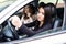 Young woman shaking hers fist sitting in vehicle drive her car