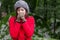 Young woman shivering with cold on a forest