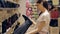 Young woman in a shoe shop examining boots