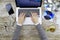 Young woman shooting from above working on laptop on wooden table listening to music cd with a cup of tea and headphone