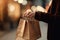 Young woman with shopping bags on city street, closeup. Winter sale, A female consumer holding a shopping bag with product, AI