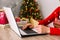 Young woman shopping for christmas presents online