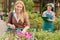 Young woman shopping flowers in garden center