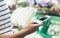 Young woman shopping healthy food in supermarket blur background. Female hands buy products cabagge using smartphone in store