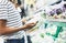 Young woman shopping healthy food in supermarket blur background. Female hands buy products cabagge using smartphone in store