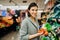 Young woman shopping in the supermarket grocery store.Buying organic vegetables sustainable produce.Natural source of vitamins and