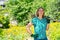 Young woman with a shovel in her hands, gardening in her garden. The concept of summer gardening