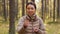 Young woman showing mushroom in autumn forest