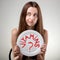 Young woman showing plate with vitamins