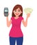 Young woman showing pos terminal or credit/debit cards swiping machine and holding cash/money/currency notes. Wireless modern bank