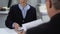 Young woman showing report to financial director, female assistant in office