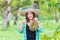 Young woman showing thumbs up in the durian farm. Asian women showing Monthong durian in the durian garden. Chanthaburi, Thailand
