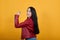 Young woman showing thumbs up studio portrait, religious lifestyle concept