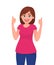 Young woman showing thumps up sign or gesture. Deal, approve, agree, okay, positive concept. Human emotion concept.