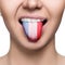 Young woman showing tongue with france flag.