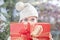 Young woman shows her gift packs inside a Christmas shop