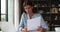 Young woman sit at workplace desk holds papers learns documents