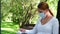 Young woman sits alone in a Park in a mask and reads a book during the epidemic. Safety, distance, health, N1H1, virus