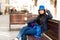 A young woman sits on a bench in the old street, and resting. Lviv, Ukraine