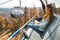 Young woman sits in cable car elevator and smiles while looks at