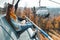 Young woman sits in cable car elevator and smiles while looks at autumn landscape