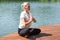 Young woman sits relaxed in nature. outdoor recreation. Meditation in nature.