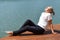 Young woman sits relaxed in nature. outdoor recreation. Meditation in nature.