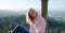 Young woman sits on the wall of Palace of Pena in Portugal - CITY OF LISBON - SINTRA. PORTUGAL - OCTOBER 15, 2019