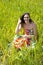 Young woman sitted in a field of flowers.