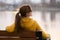 Young woman sitting alone on park bench relaxing on warm autumn day