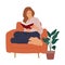 Young woman sitting in armchair, reading book.