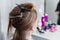 Young woman sitting in beauty hair salon style and waiting for hairdresser to make hairdo