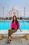 Young woman sitting on a bench at Taj Mahal complex in Agra, Uttar Pradesh, India