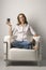 Young Woman Sitting in Chair with Camera